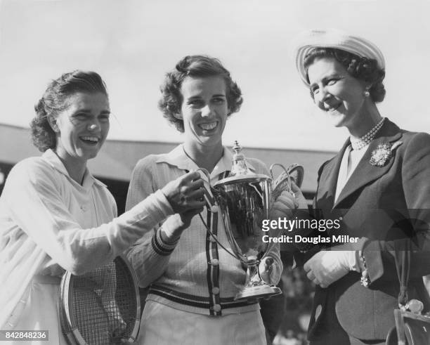 The Duchess of Kent presents the trophy to American tennis players Shirley Fry and Doris Hart , after they beat Louise Brough and Margaret Osborne...