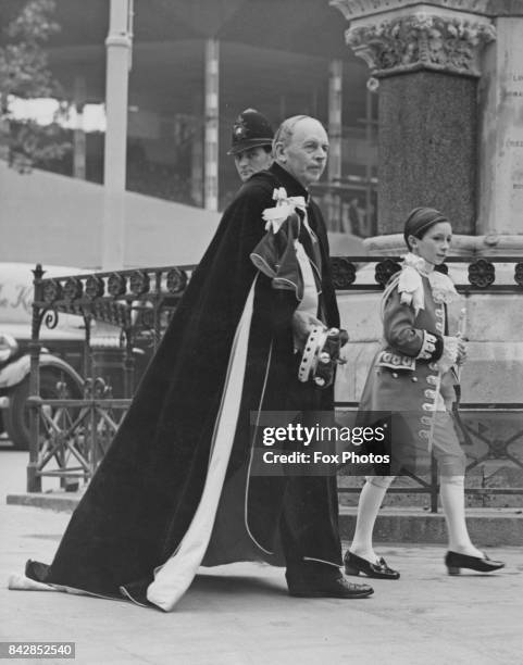 William Ormsby-Gore, 4th Baron Harlech , the Standard Bearer for the Principality of Wales, arrives at Westminster Abbey with his page Julian...