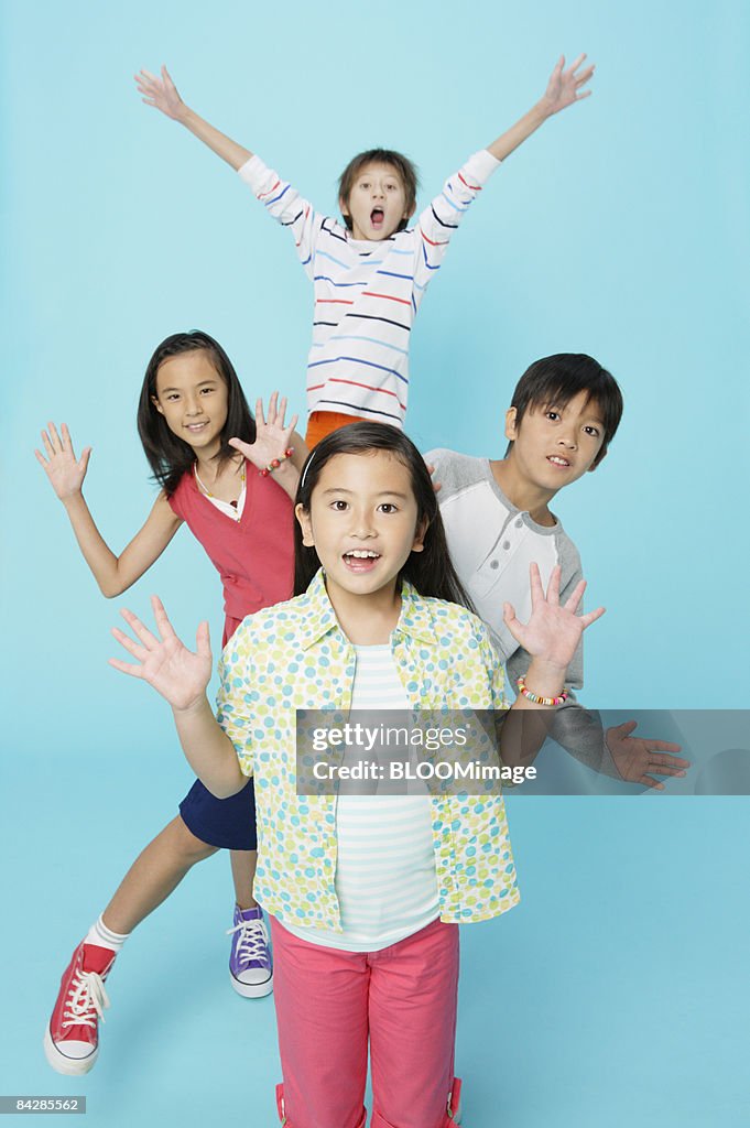 Boys and girls making pose, studio shot