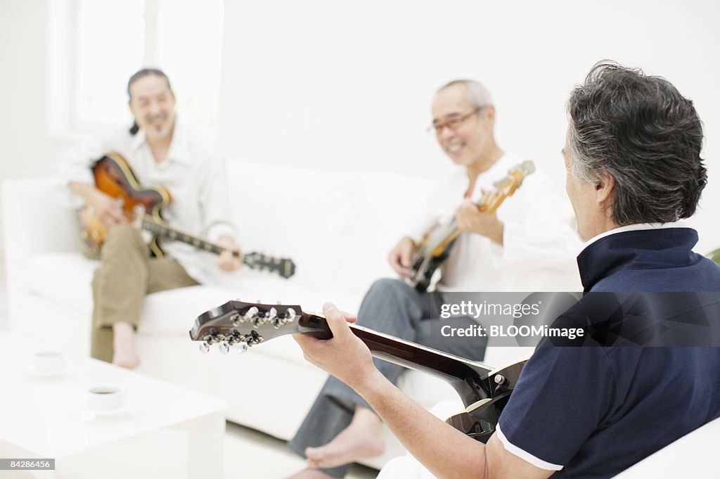Men playing guitars and bass guitar