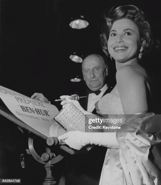 Israeli actress Haya Harareet signs a scroll at the premiere of the film 'Ben Hur' at the Empire, Leicester Square, London, 16th December 1959. She...