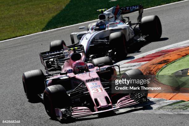 Esteban Ocon of France driving the Sahara Force India F1 Team VJM10 leads Lance Stroll of Canada driving the Williams Martini Racing Williams FW40...