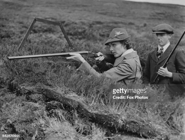 Marjorie Merriweather Post , the former wife of Edward Francis Hutton, goes grouse shooting on Fetteresso Moor in Kincardineshire, Scotland, as the...