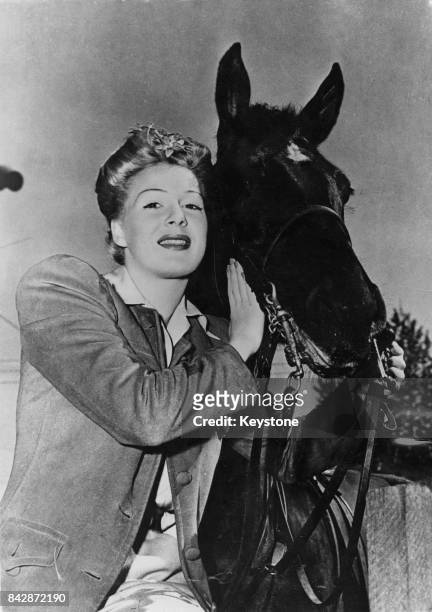 American actress Betty Hutton takes up horse riding, 1946.