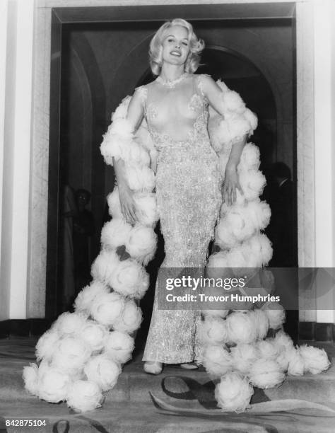 American actress Carroll Baker wears a partially-transparent dress to the post-premiere reception for her latest film 'The Carpetbaggers' at...