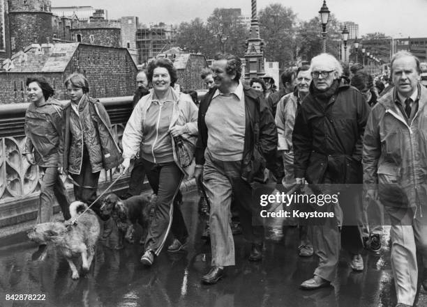 Labour politicians Denis Healey and Michael Foot lead Shadow Cabinet members through the rain on an 11-mile sponsored walk over 10 Thames Bridges in...