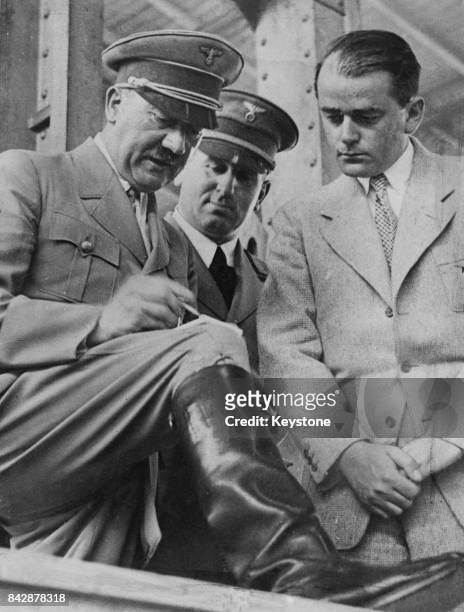 German Chancellor Adolf Hitler and architect Albert Speer go through the arrangements at Nuremberg, Germany, before the Reichsparteitag or Nuremberg...