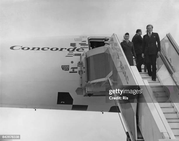 Queen Elizabeth II and Michael Heseltine, the Minister for Aerospace, inspect the supersonic jet airliner Concorde after its sales tour flight to 11...