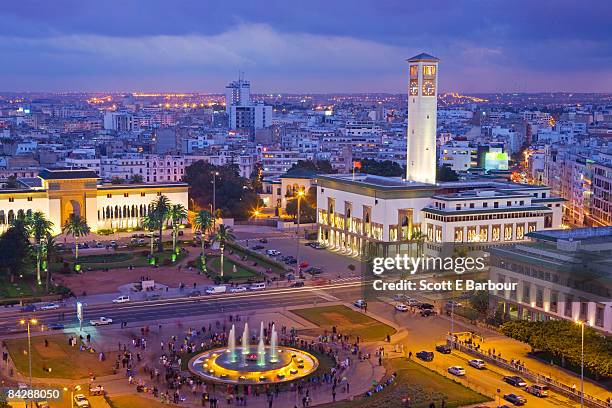 place mohammed v and city skyline, dusk - marokko stock-fotos und bilder