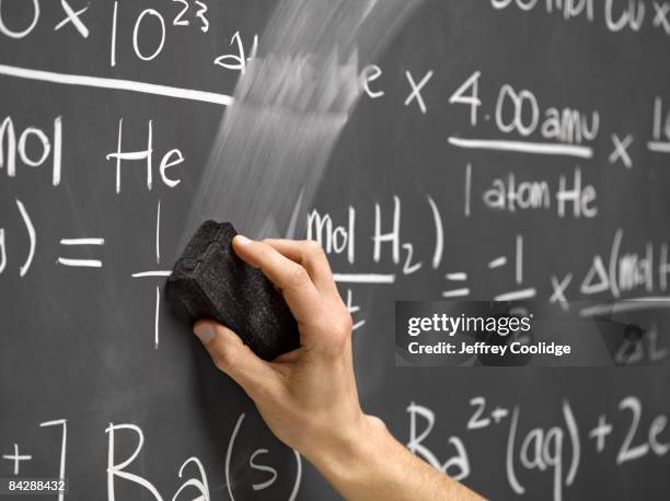 hand erasing equations on blackboard - gomme photos et images de collection