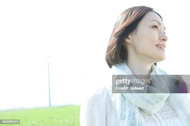 japanese woman smiling on grass, portrait - 女性　日本人　笑顔　30代 ストックフォトと画像