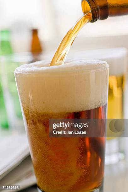 beer pour - overflowing beer stock pictures, royalty-free photos & images