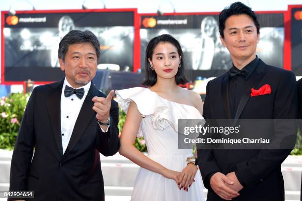 Hirokazu Koreeda, Suzu Hirose and Koji Yakusho walk the red carpet ahead of the 'The Third Murder ' screening during the 74th Venice Film Festival at...