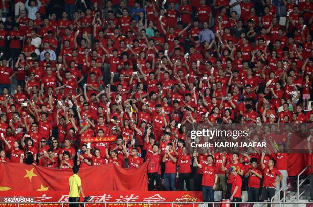 Chinese fans cheer prior to the start of the FIFA World Cup 2018 qualification football match between Qatar and China at the Khalifa International...