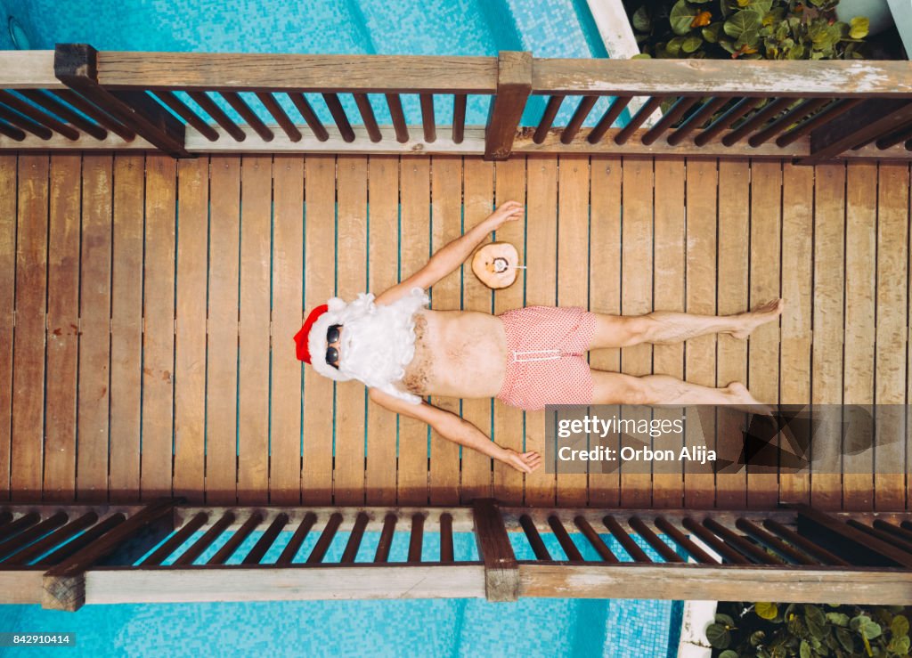 Santa Claus relaxing at the pool