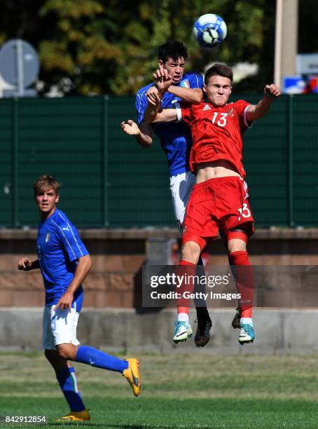 Viacheslav Grulev of Russia U19 competes for the ball with Alessandro Bastoni of Italy U19 during the match between Italy U19 and Russia U19 at...