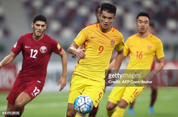 China's Xiao Zhi controls the ball during the FIFA World Cup 2018 qualification football match between Qatar and China at the Khalifa International...