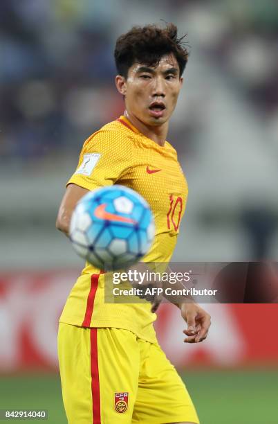 China's captain Zheng Zhi eyes the ball during the FIFA World Cup 2018 qualification football match between Qatar and China at the Khalifa...