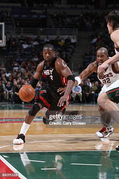 Dwyane Wade of the Miami Heat drives to the basket against Michael Redd of the Milwaukee Bucks on January 14, 2009 at the Bradley Center in...