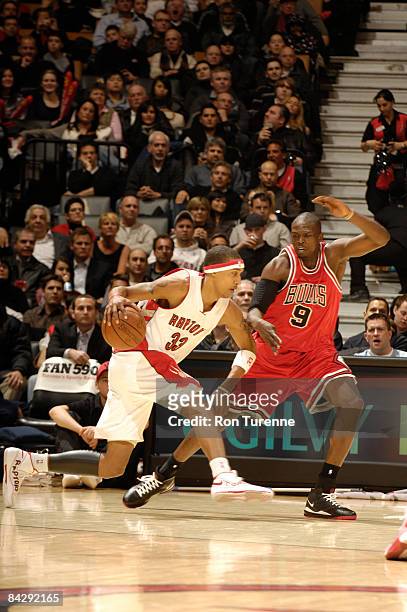 Jamario Moon of the Toronto Raptors works against the defense of Luol Deng of the Chicago Bulls on January 14, 2009 at the Air Canada Centre in...