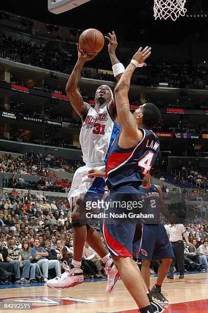 Ricky Davis the Los Angeles Clippers goes to the basket against Acie Law of the Atlanta Hawks at Staples Center on January 14, 2009 in Los Angeles,...