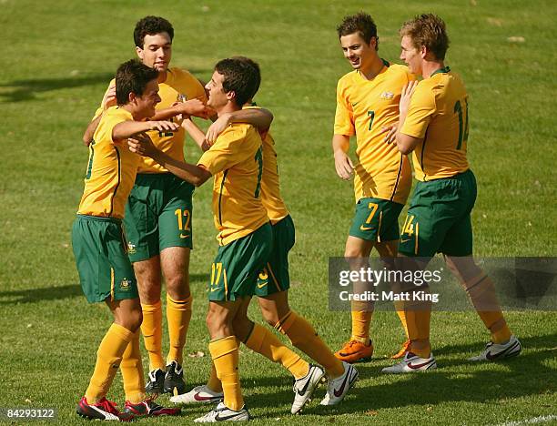 James Virgili of Australia celebrates with team mates after scoring the first goal during the football match between Australia and China during day...