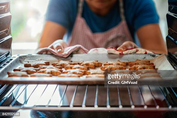 baking gingerbread cookies in the oven - baking stock pictures, royalty-free photos & images