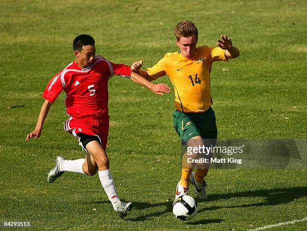 Tyler Thurtell of Australia and Duan Yu of China challenge for the ball during the football match between Australia and China during day two of the...