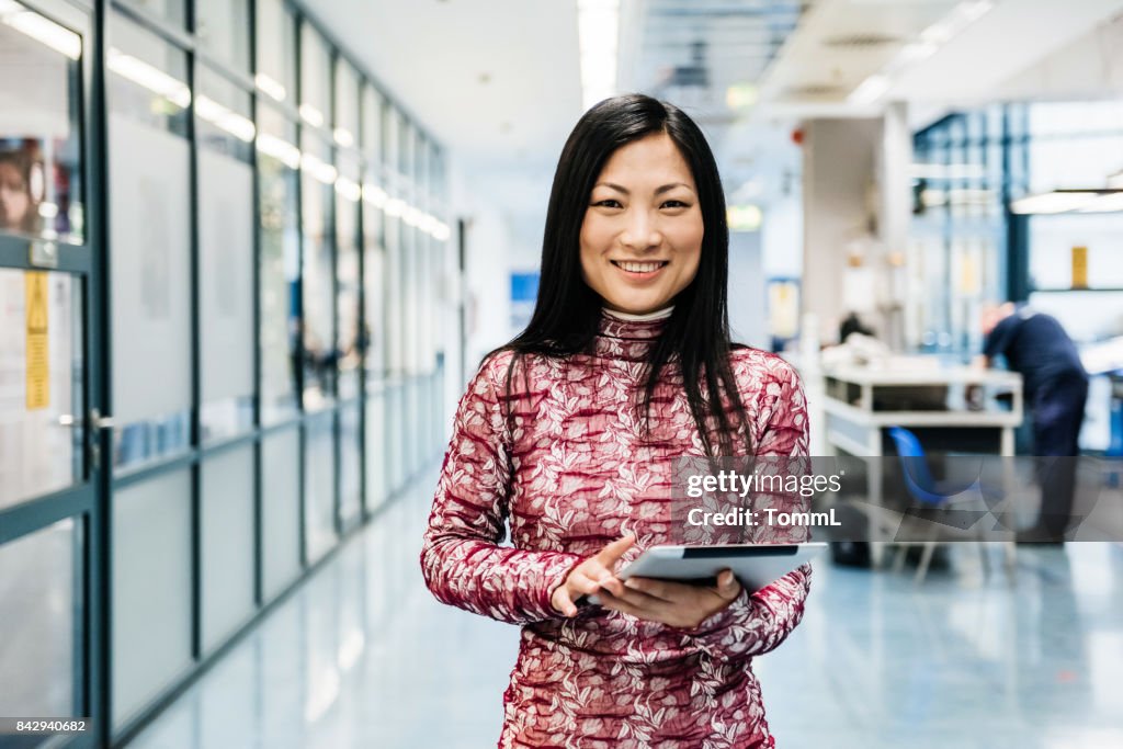 Asian Engineer With Digital Tablet In Factory