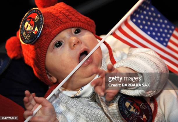 Dorian Neiman, four-month-old visitor of Berlin's Madame Tussaud's wax museum, holds a US flag and wears Obama-stickers during the presentation of a...