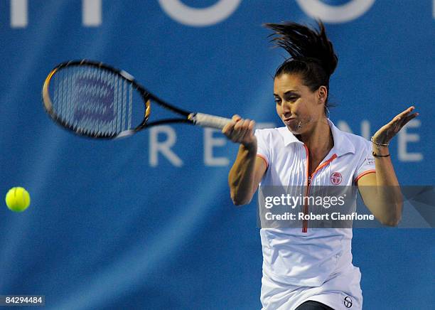 Flavia Pennetta of Italy returns a shot to Iveta Benesova of and Barbora Zahlavova Strycova of the Czech Republic during the semi finals doubles...
