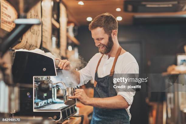 male barista making cappuccino - barista coffee restaurant stock pictures, royalty-free photos & images