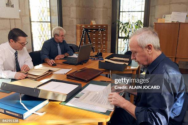 Dortmund's prosecutor, Ulrich Maass and a colleague work on historical documents on January 15, 2009 in the French western town of Tours, where he...