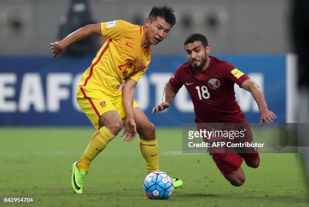 China's Yu Hanchao and Qatar's Abdulkareem Salem fight for the ball during the FIFA World Cup 2018 qualification football match between Qatar and...