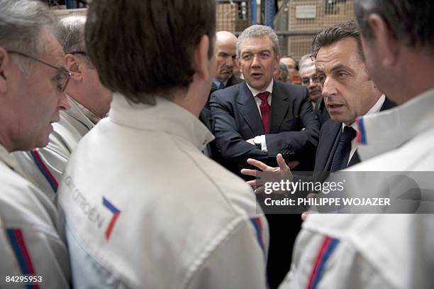 French President Nicolas Sarkozy and PSA Peugeot Citroen Chief Executive Christian Streiff speak with union representatives during a visit to a...