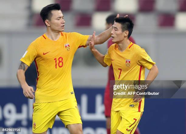 Chinese players celebrate during the FIFA World Cup 2018 qualification football match between Qatar and China at the Khalifa International Stadium in...