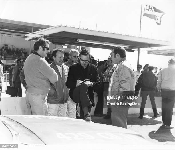Veteran TV newsman Chris Economaki is flanked by some of the sport's greatest drivers, including A.J. Foyt Pete Hamilton and NASCAR President Bill...