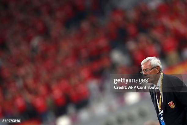 China's Italian Head Coach Marcello Lippi watches the FIFA World Cup 2018 qualification football match between Qatar and China at the Khalifa...