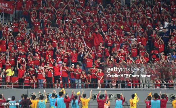 China's fans cheer during the FIFA World Cup 2018 qualification football match between Qatar and China at the Khalifa International Stadium in Doha...