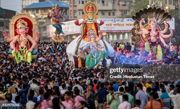 Devotees prepare to immerse idols of elephant-headed Hindu God Ganesha in the Arabian Sea, marking the end of the 10-day long Ganesh Chaturthi...