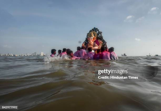 Devotees prepare to immerse idols of elephant-headed Hindu God Ganesha in the Arabian Sea, marking the end of the 10-day long Ganesh Chaturthi...