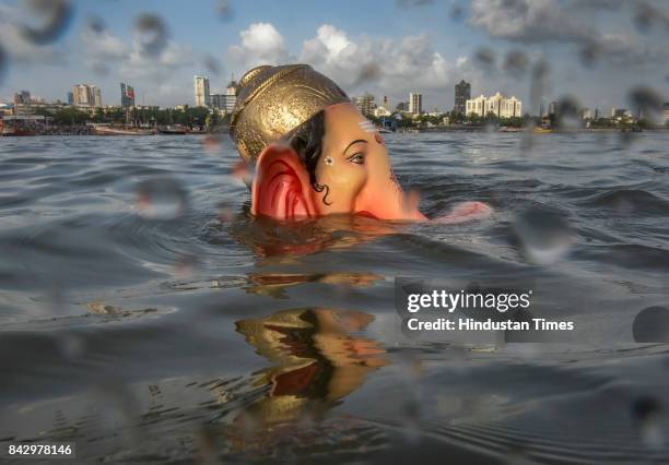 Devotees prepare to immerse idols of elephant-headed Hindu God Ganesha in the Arabian Sea, marking the end of the 10-day long Ganesh Chaturthi...