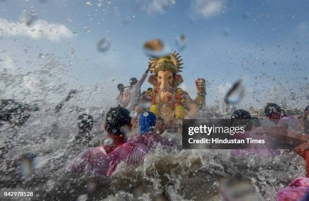 Devotees prepare to immerse idols of elephant-headed Hindu God Ganesha in the Arabian Sea, marking the end of the 10-day long Ganesh Chaturthi...