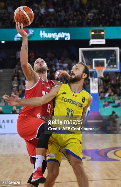 Octavian Calota-Popa of Romania vies with David Vojvoda of Hungary during a Group C basketball match at the FIBA Eurobasket 2017 in Cluj Napoca,...