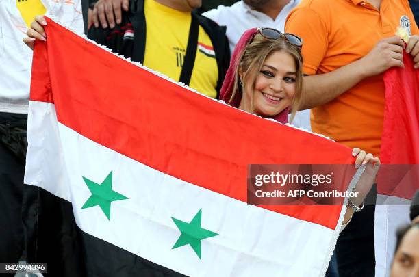 Supporter of Syria's national team attends the FIFA World Cup 2018 qualification football match between Syria and Iran at the Azadi Stadium in Tehran...