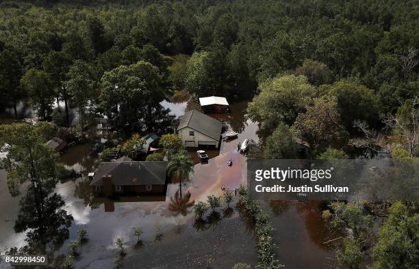 Home is surrounded by floodwaters on September 5, 2017 near Beaumont, Texas. The Army National Guard is using helicopters to drop hay for cattle that...