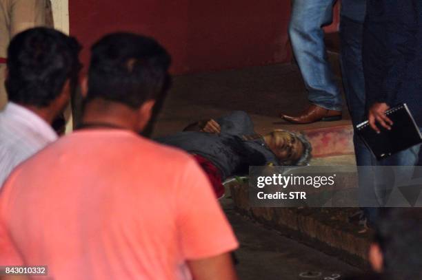 Graphic content / TOPSHOT - Karnataka State Police officials investigate the crime scene where the body of 55-year-old Gauri Lankesh, who was shot...