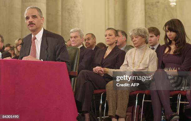 Eric Holder, Attorney General Designate, gives his opening statement on Capitol Hill to the Senate Judiciary Committee, as his wife, Dr. Sharon...