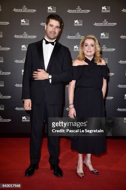 Deputy CEO of Jaeger-LeCoultre Geoffroy Lefebvre and Catherine Deneuve arrive for the Jaeger-LeCoultre Gala Dinner during the 74th Venice...