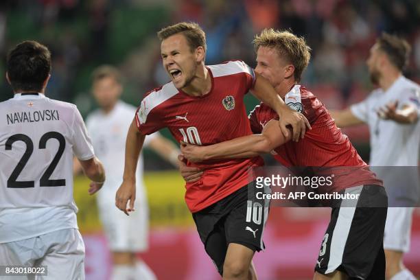 Austria's Louis Schaub celebrates scoring an equalizer making it 1-1 during the Group D FIFA World Cup 2018 qualification match between Austria and...